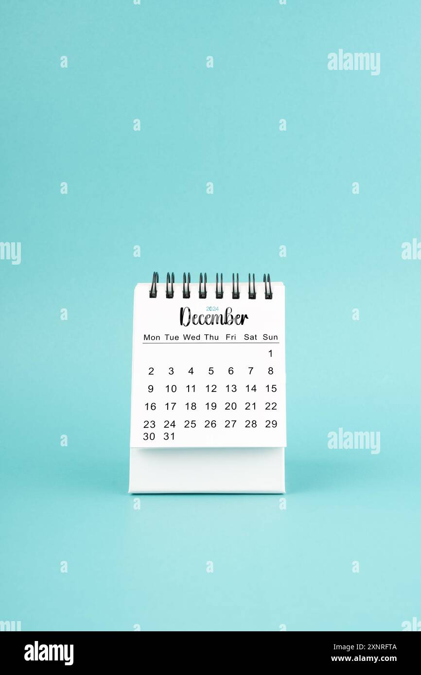 December 2024 white desk calendar on blue color background Stock Photo ...