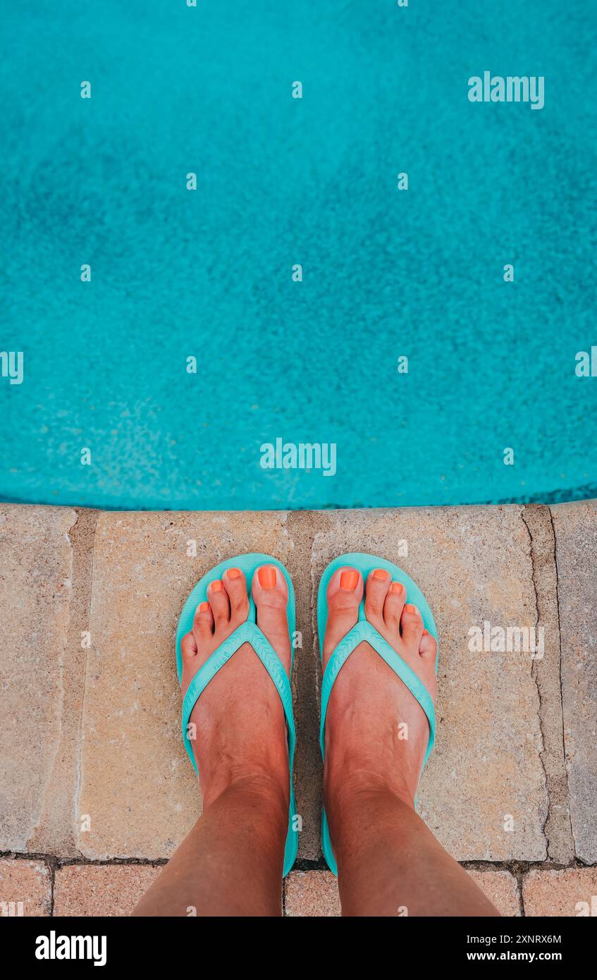 Female feet standing at edge of outdoor swimming pool from above Stock ...