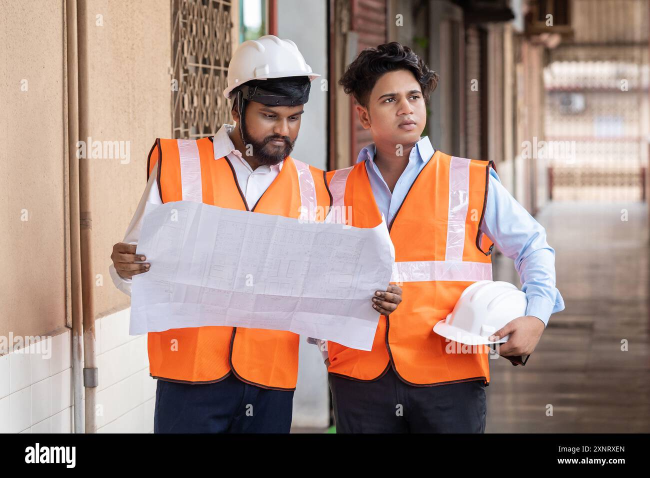 Engineers Discussing Project at Construction Site Working Stock Photo