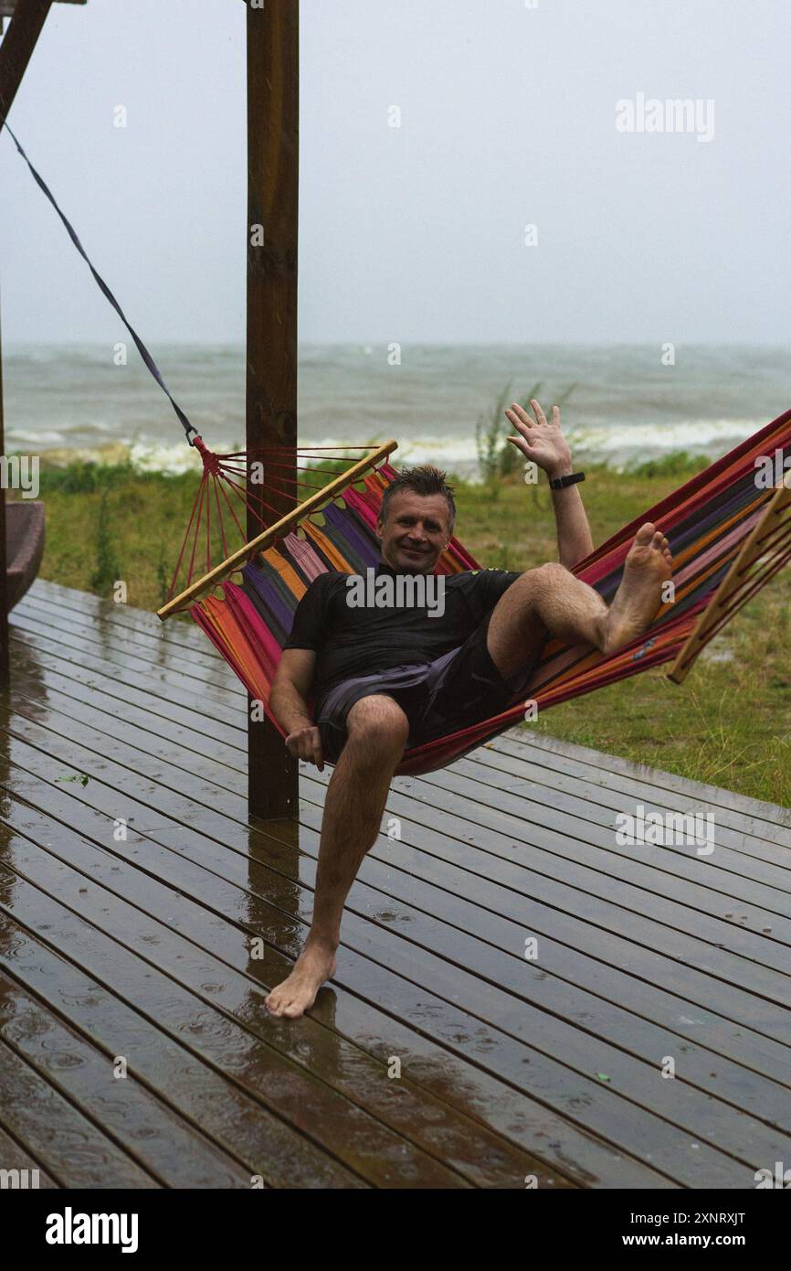 Mid adult man lying in hammock hi-res stock photography and images - Alamy