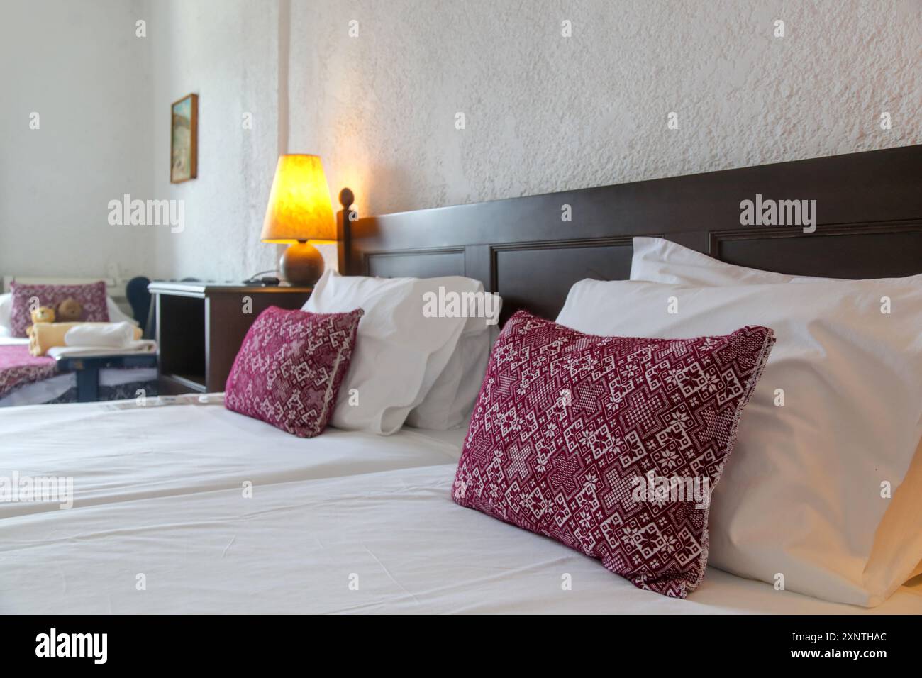 Retro bedroom style with red pattern pillows on bed Stock Photo
