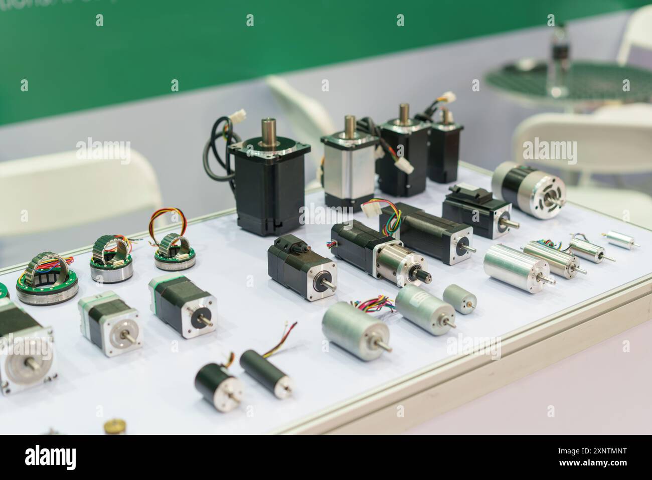 array of electric motors, including stepper motors, servo motors, and DC motors, displayed on a white surface Stock Photo