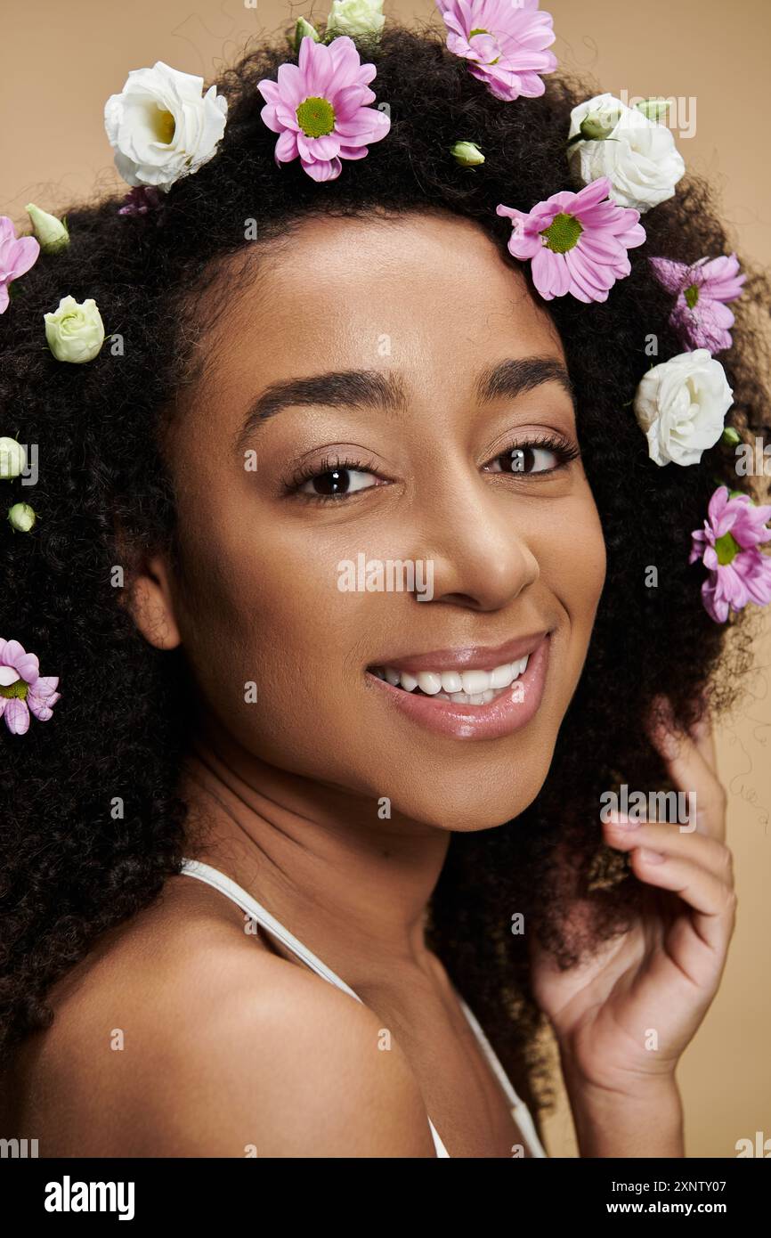 A beautiful African American woman with flowers in her hair smiles ...
