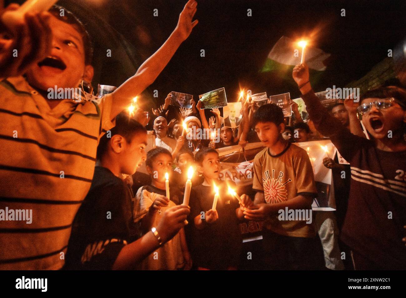 Kashmiri Shia Muslims hold candles and placards while shouting pro ...