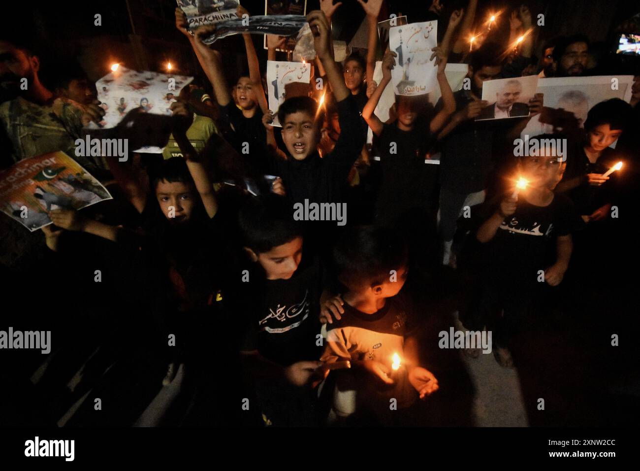 Kashmiri Shia Muslims hold candles and placards while shouting pro ...