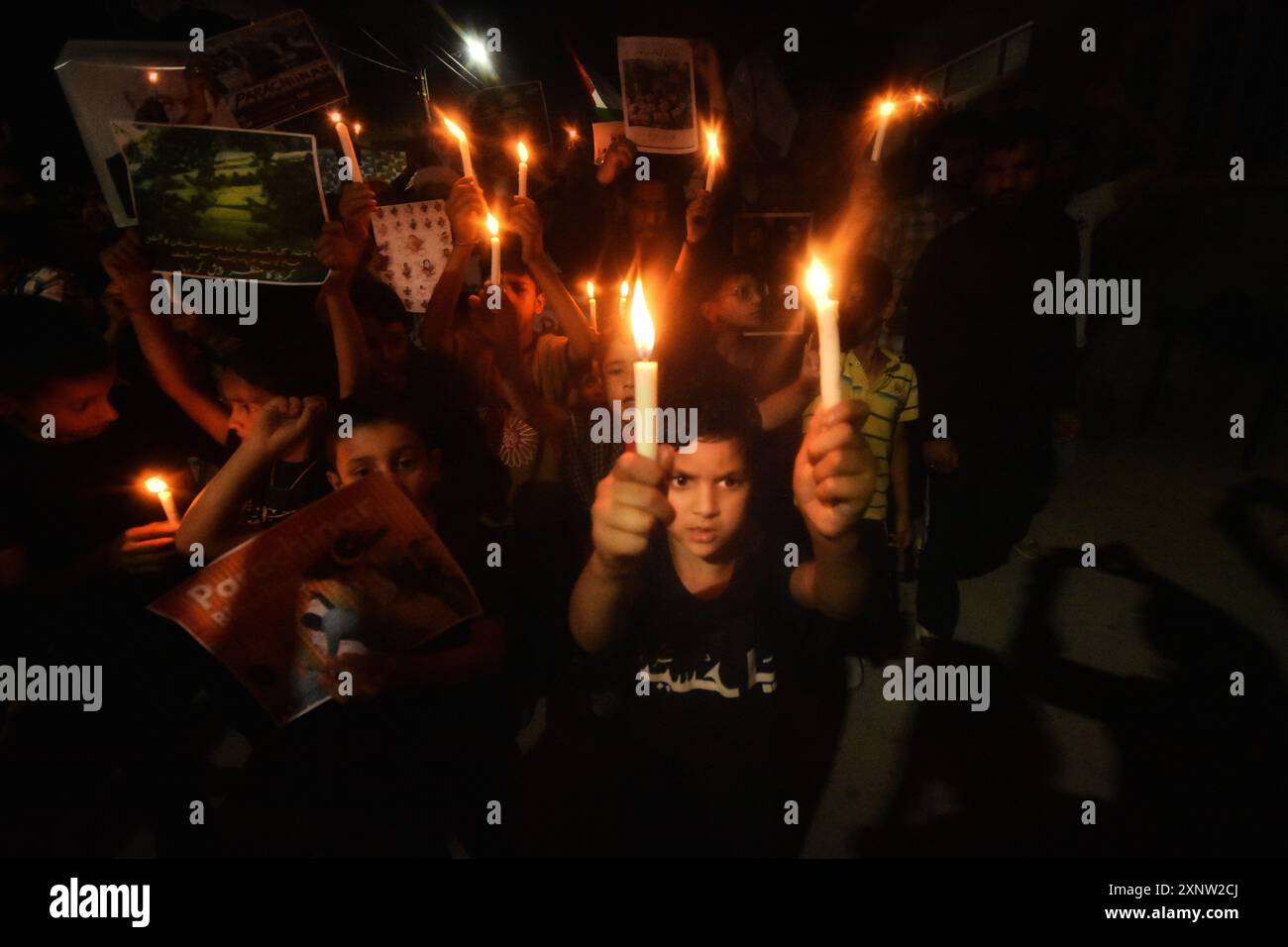 Kashmiri Shia Muslims hold candles and placards while shouting pro ...