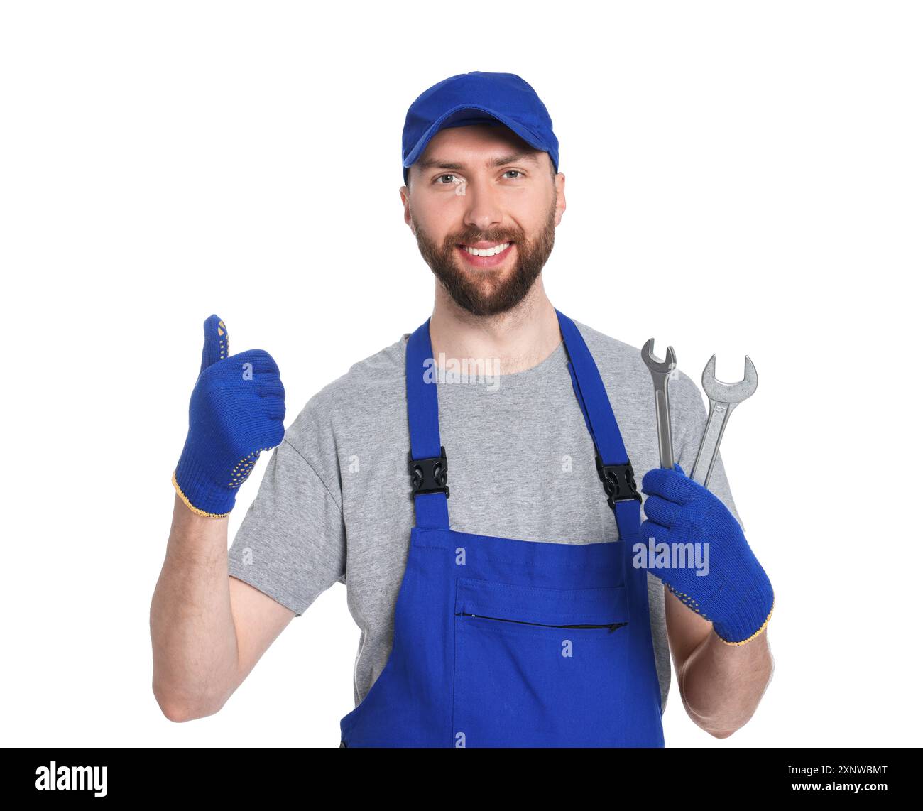 Professional auto mechanic with tools showing OK gesture on white background Stock Photo