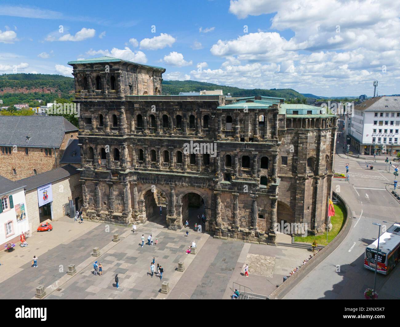 Historical architecture in sunny weather, tourists visiting Porta Nigra ...