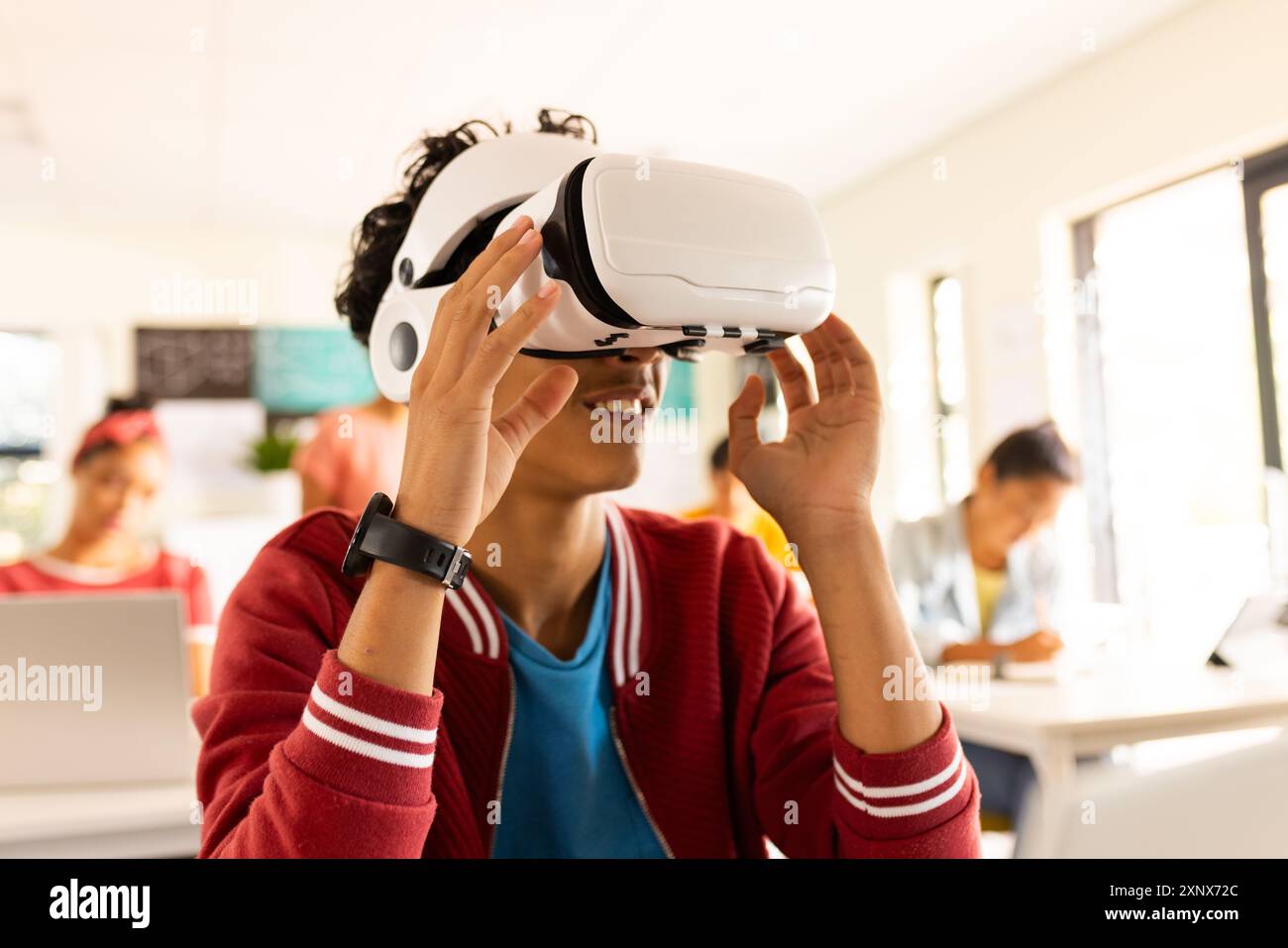 In high school, teenage boy using VR headset in classroom, exploring ...
