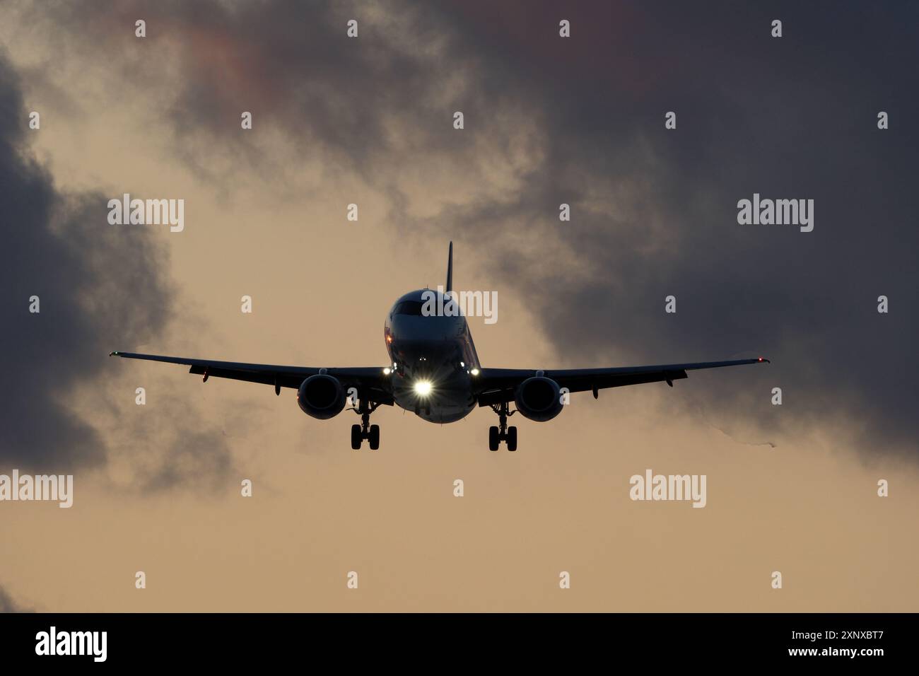 Airplane flying in the blue sky with clouds at sunset time Stock Photo ...