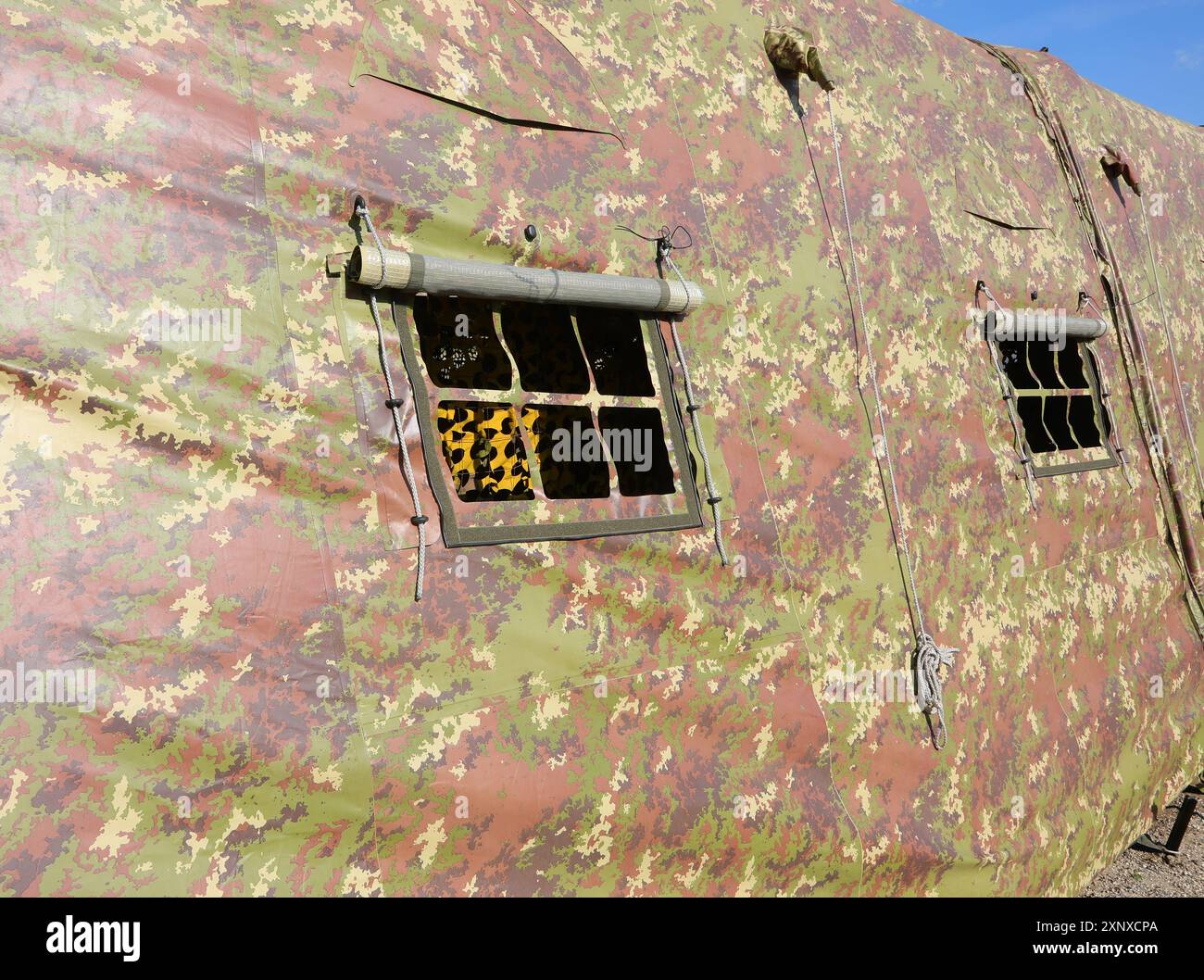 window of a military tent with camouflage fabric set up in a training ...
