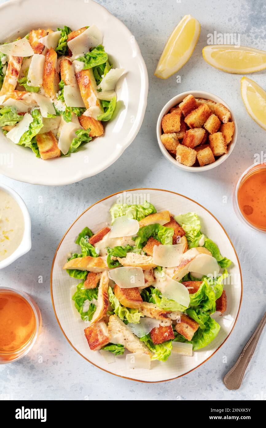 Chicken Caesar salad, shot from above with croutons and lemons Stock Photo