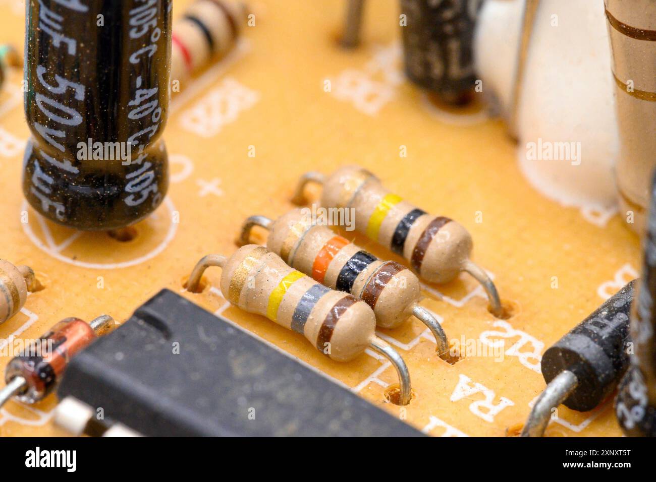 Old vintage printed circuit board with electronic components. Closeup with shallow DOF Stock Photo