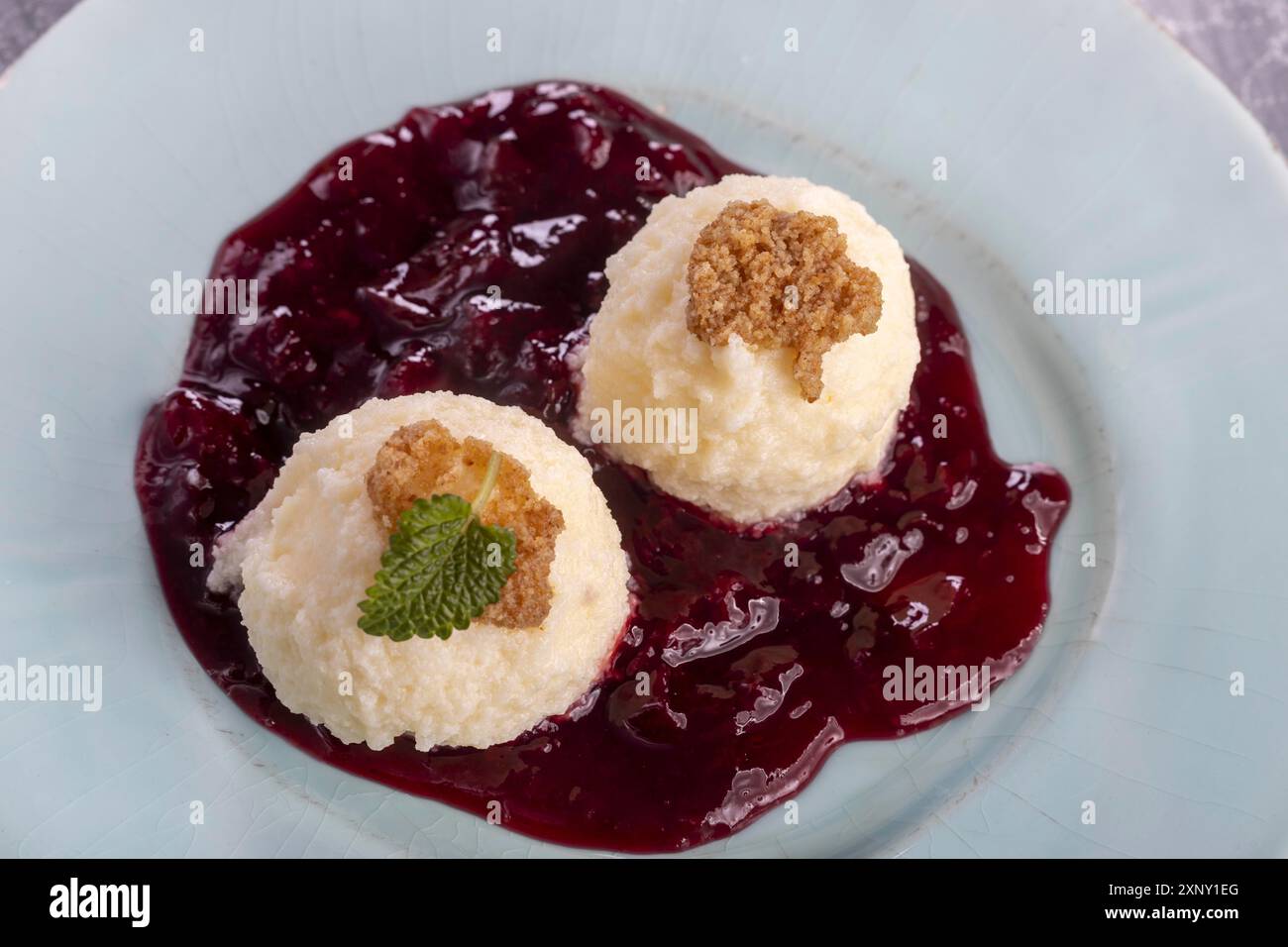 Austrian curd cheese dumplings on plum sauce Stock Photo