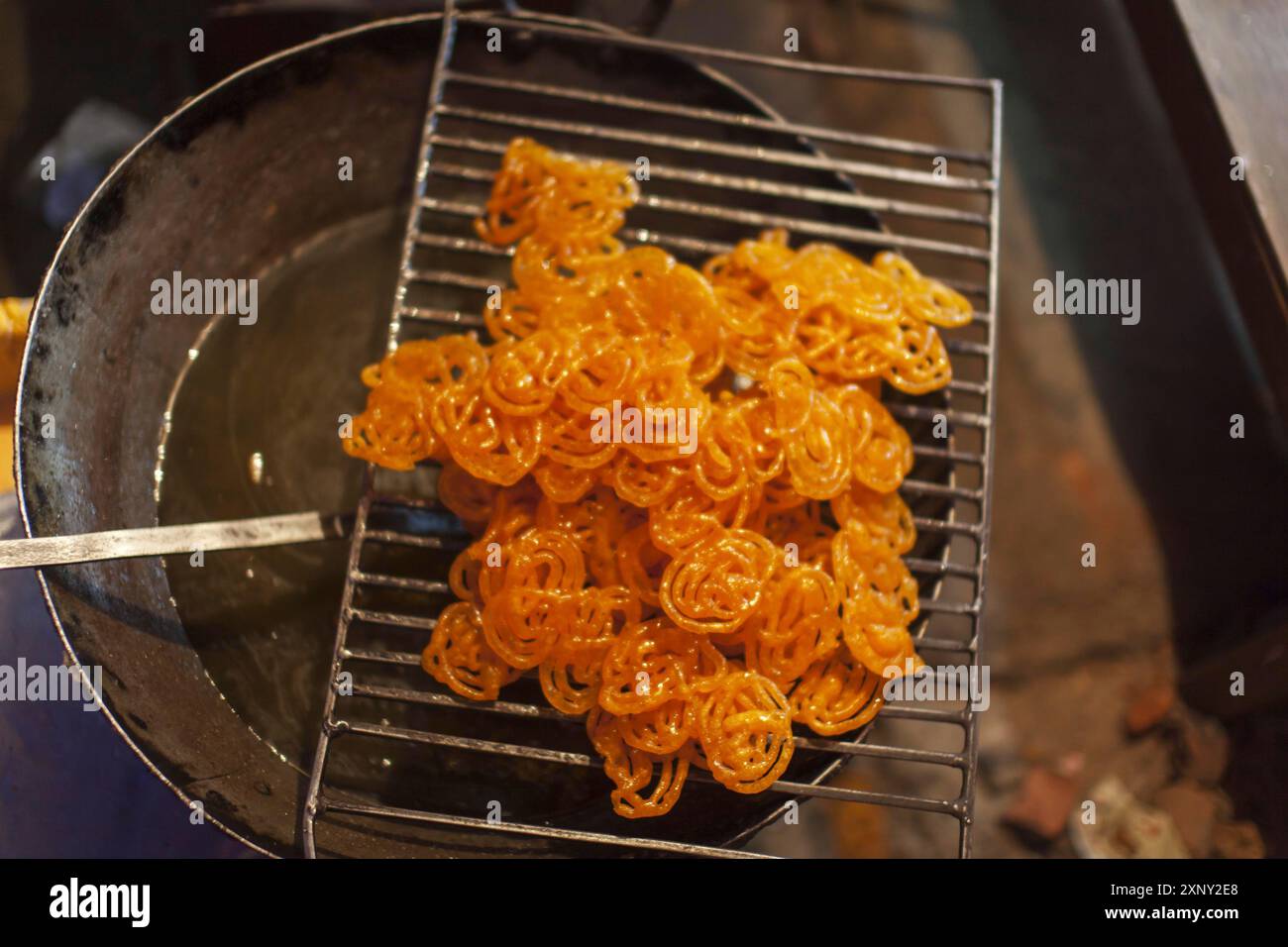 Indian jalebi sweet dessert on a grill Stock Photo