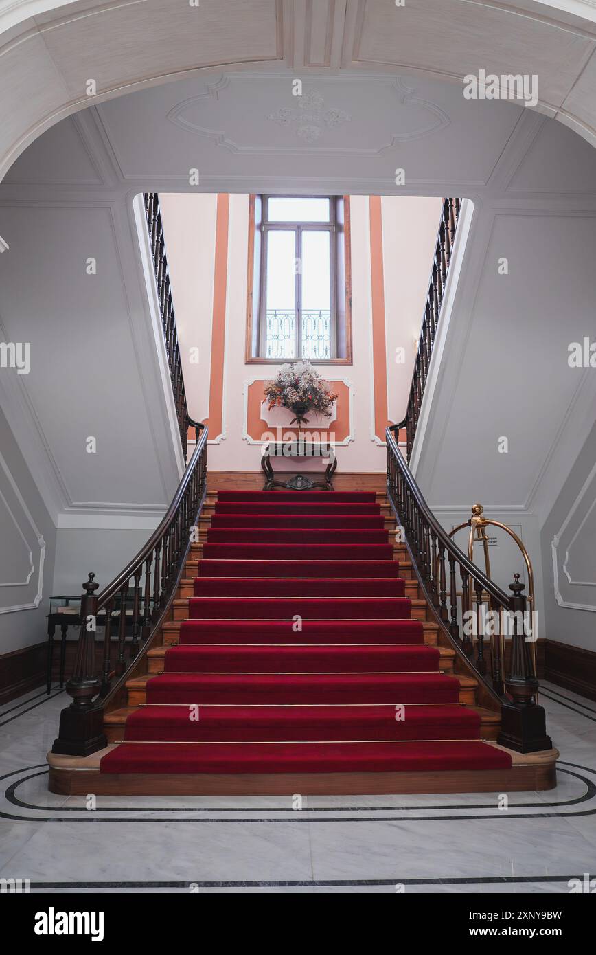 Grand Staircase with Red Carpet and Wrought Iron Railings in Luxury ...