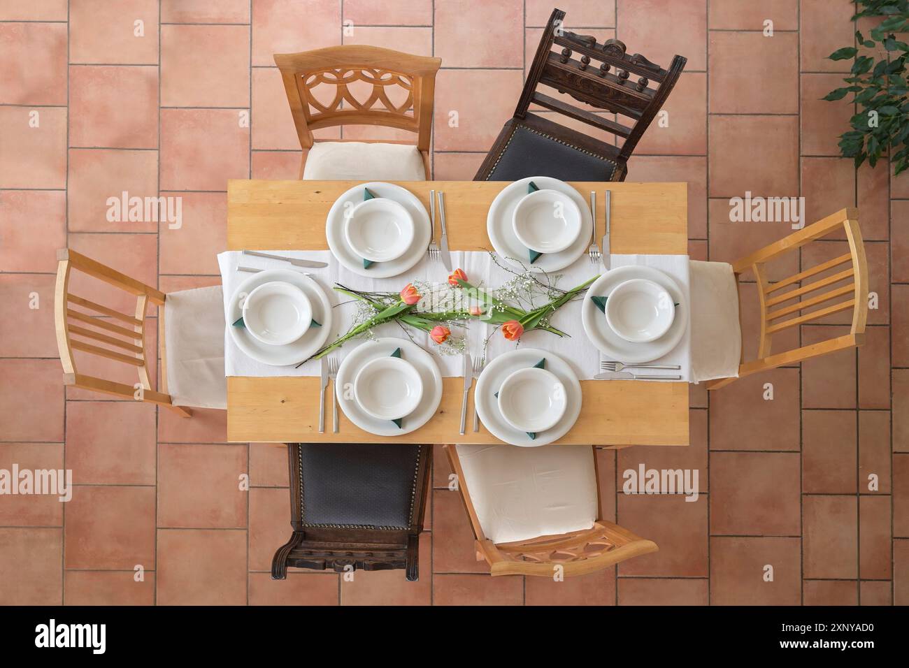 Wood Table Setup Wooden table setting with six empty white plates and bowls, cutlery and ...