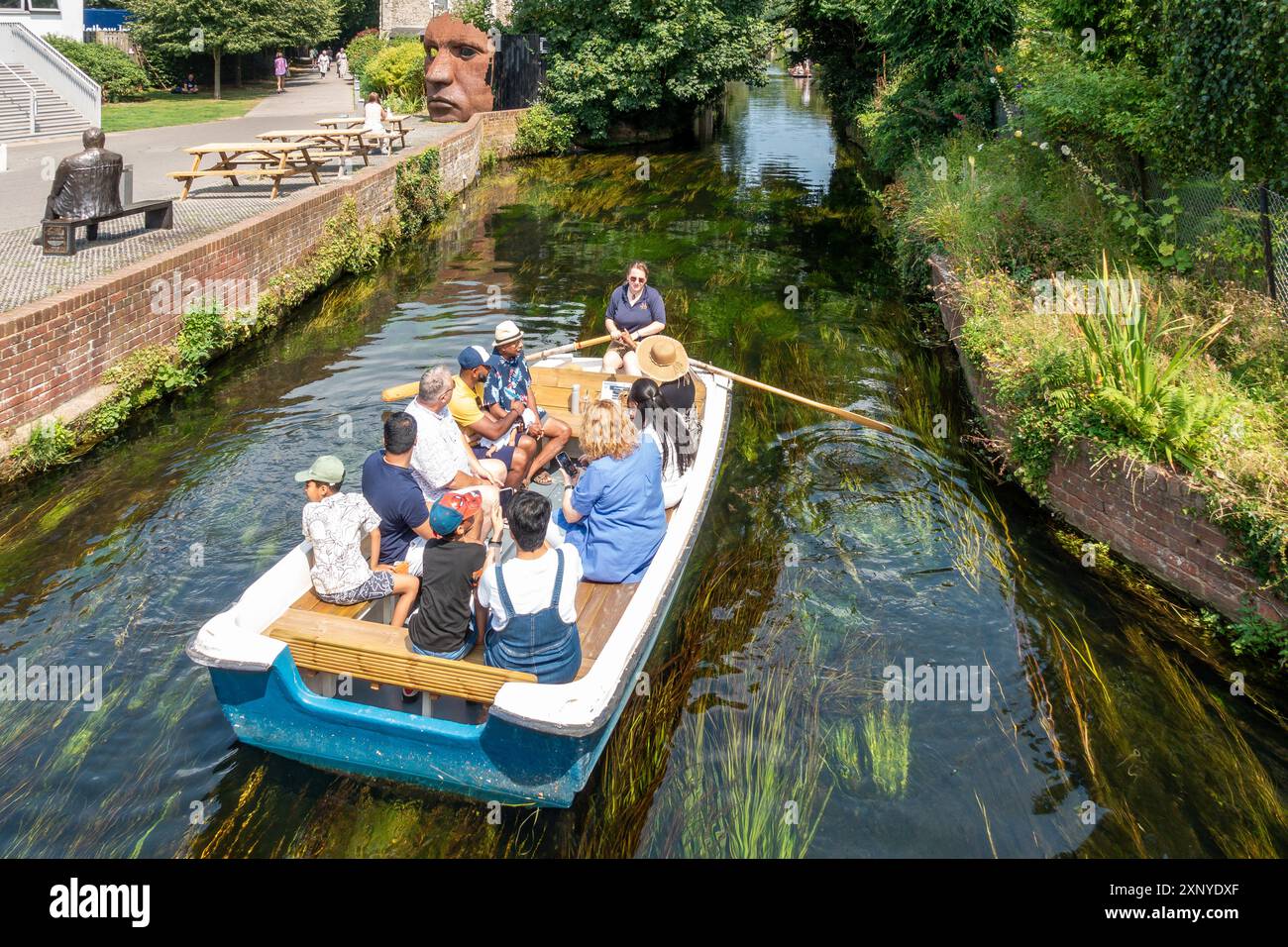 River Trip,Tour,River Stour,Canterbury,Kent,England Boat passing the Marloew Theatre and the seated statue of Canterbury comedian, Dave Lee. Stock Photo