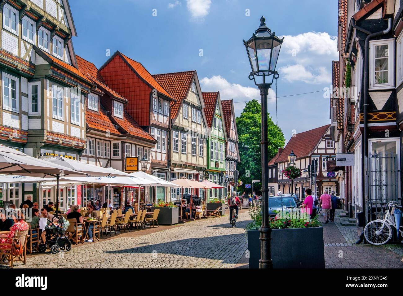 Schuhstrasse in the old town centre with typical half-timbered houses and street cafe, Celle, Lueneburg Heath, Lower Saxony, Germany Stock Photo