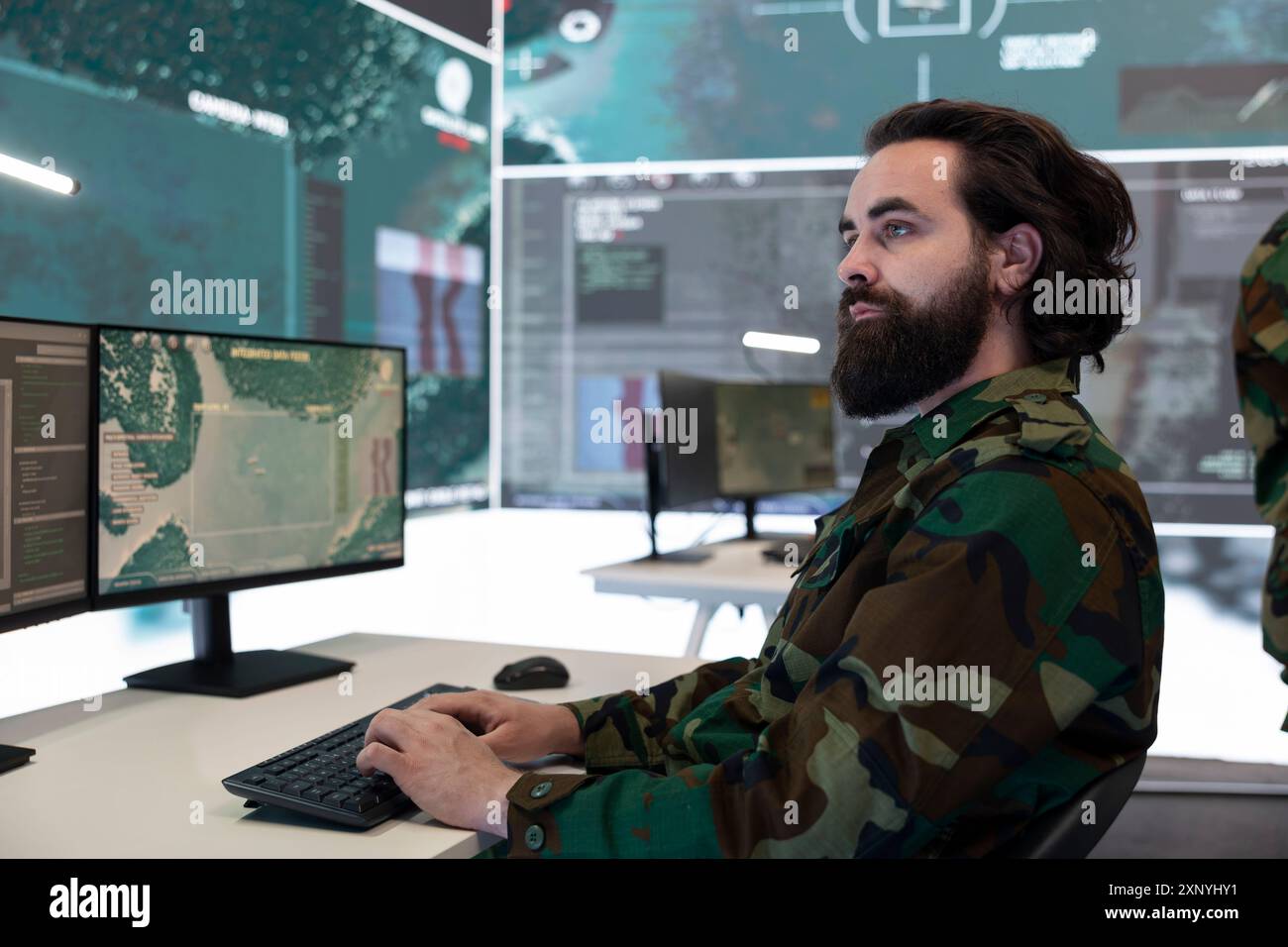 High tech specialist reviewing satellite CCTV footage on a big screen ...