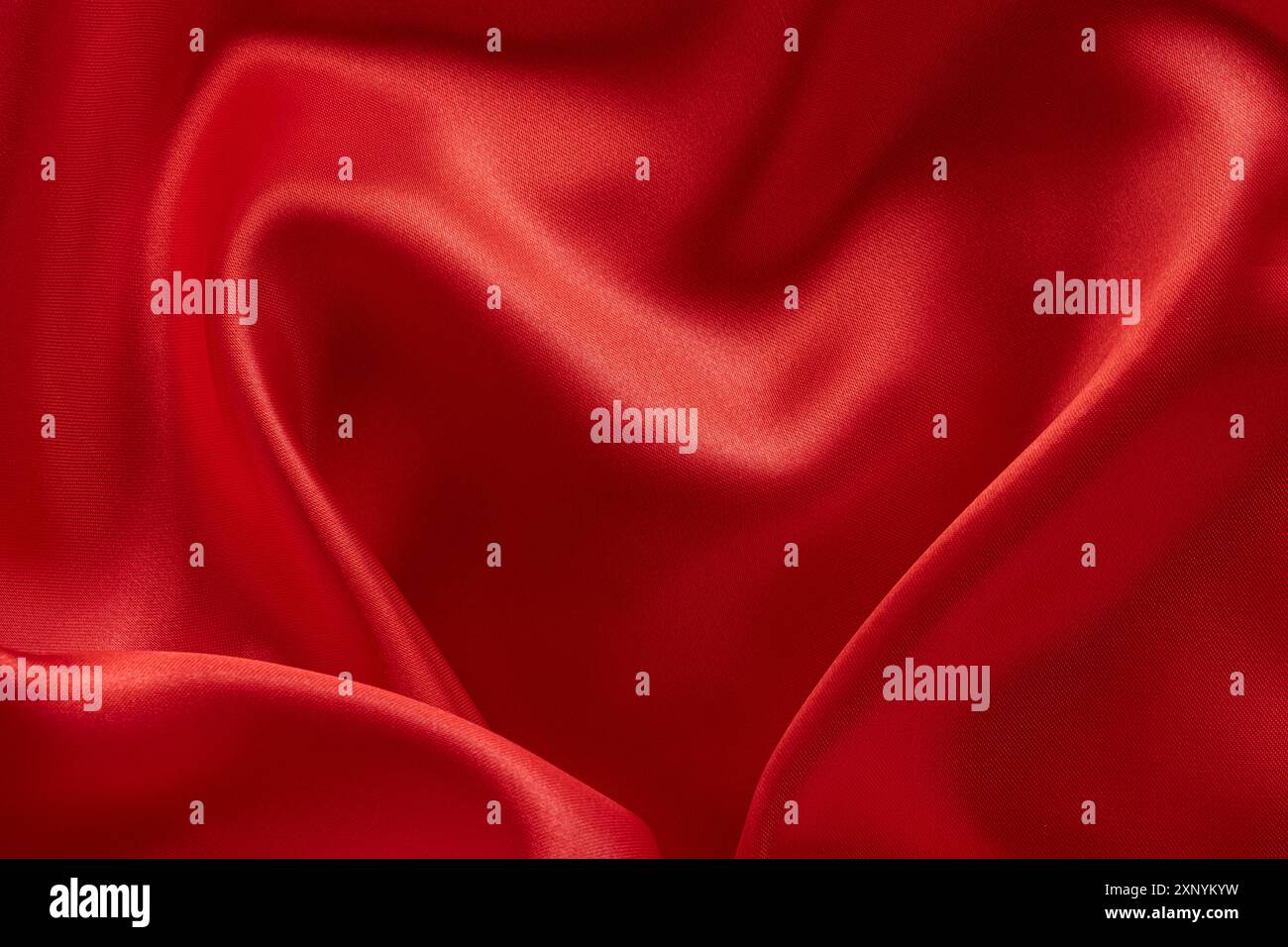 Red satin background with waves. Tissue, textile, cloth, fabric, material, texture Stock Photo