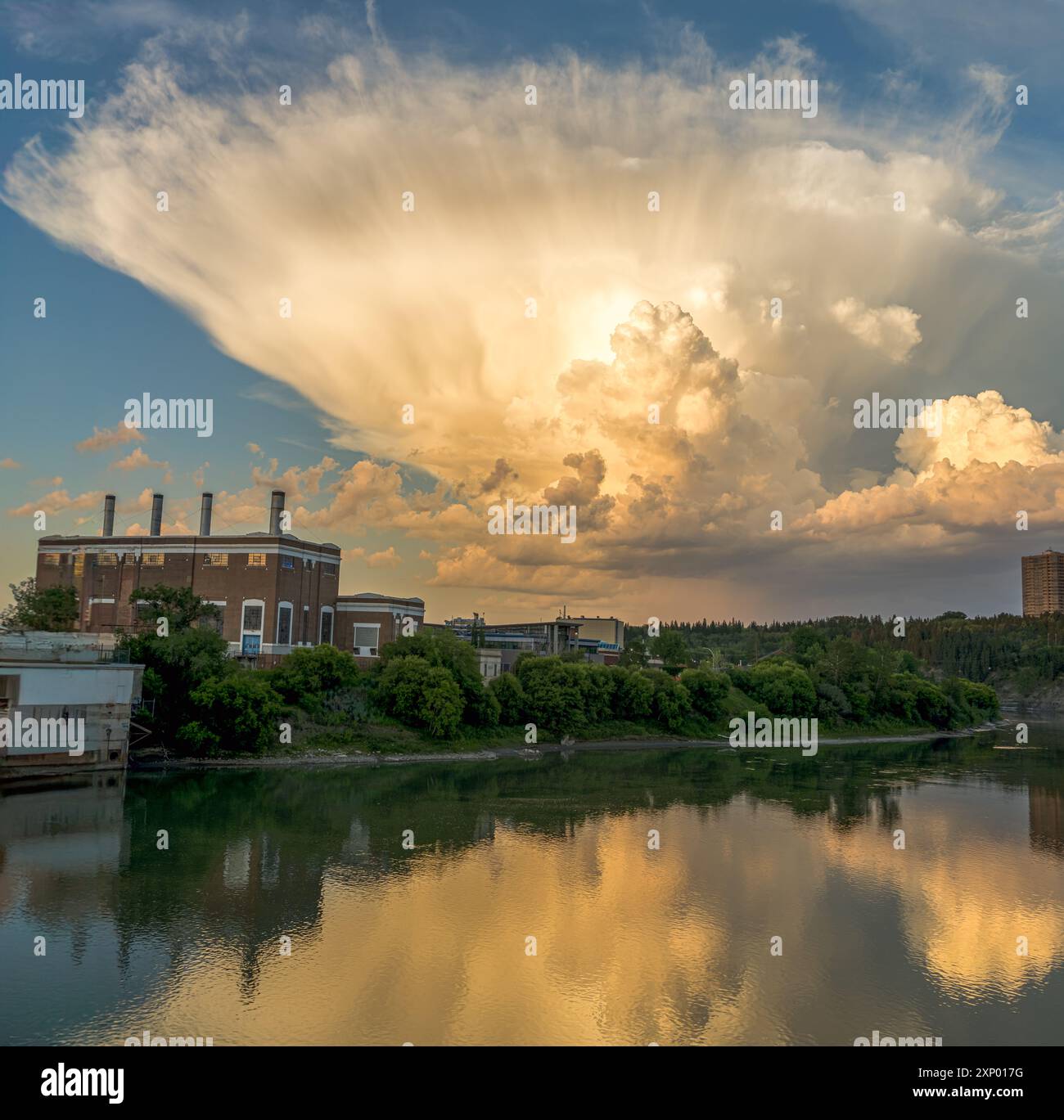 Dramatic clouds shaped as an atomic bomb explosion cloud on east side of sky during sunset time Stock Photo