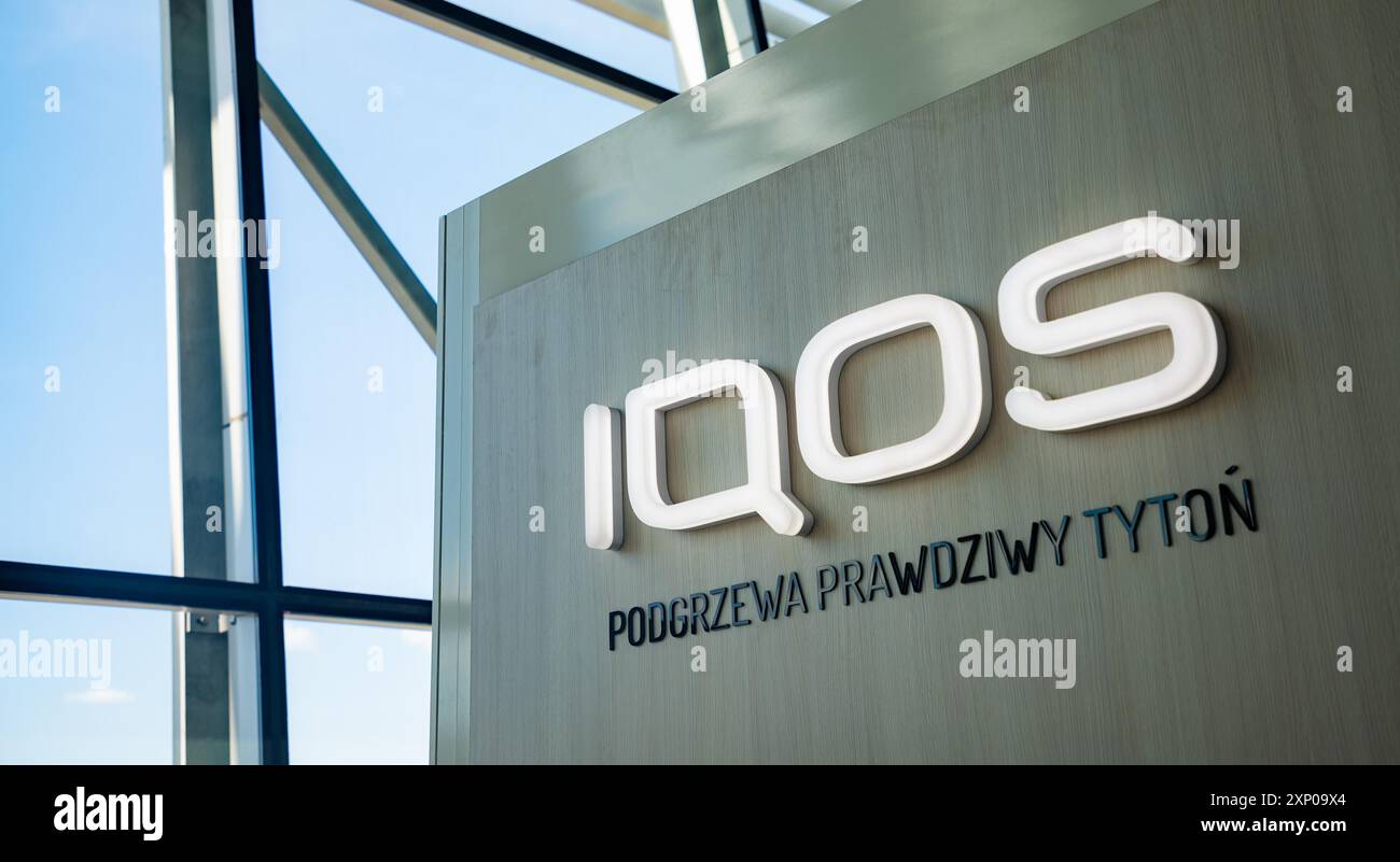 A picture of the IQOS logo on the side of a stand inside the