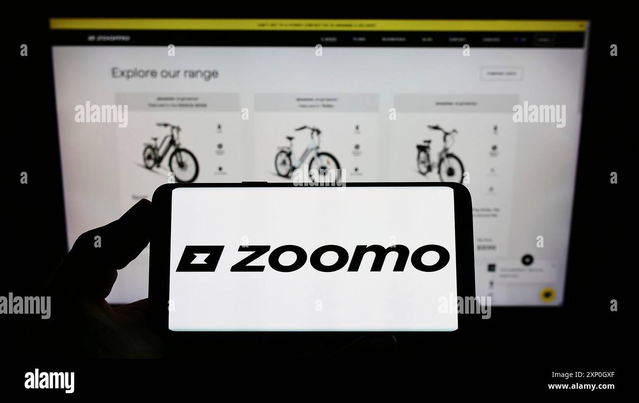 Stuttgart, Germany, 02-26-2022: Person holding mobile phone with logo of electric bicycle company Bolt Bikes (Zoomo) on screen in front of web page. Stock Photo