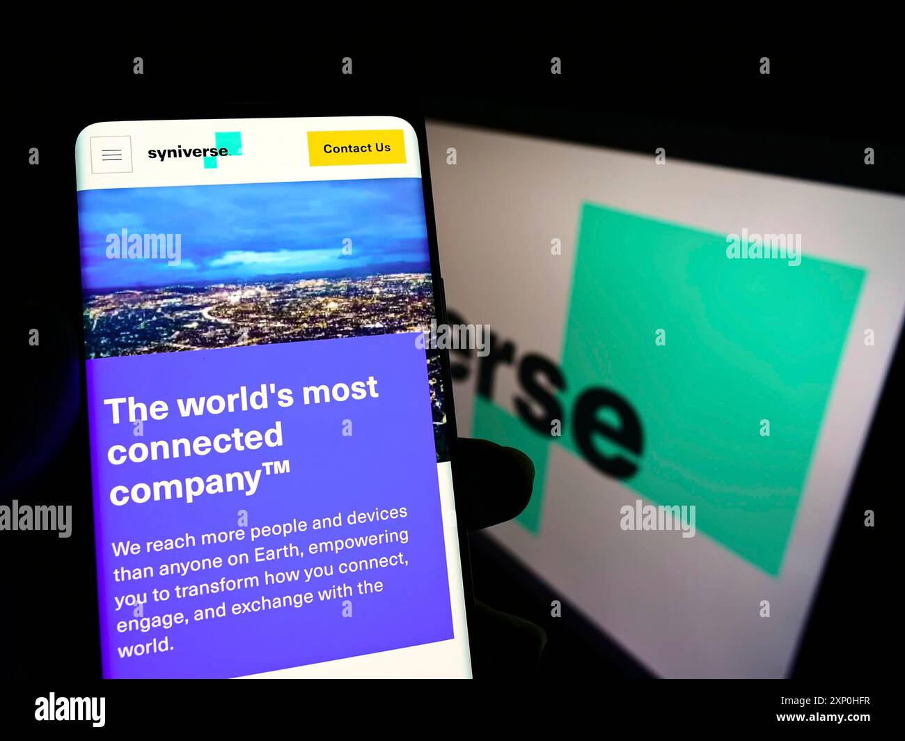 Stuttgart, Germany, 02-11-2022: Person holding smartphone with webpage of US telecom company Syniverse Technologies LLC on screen with logo. Focus on Stock Photo