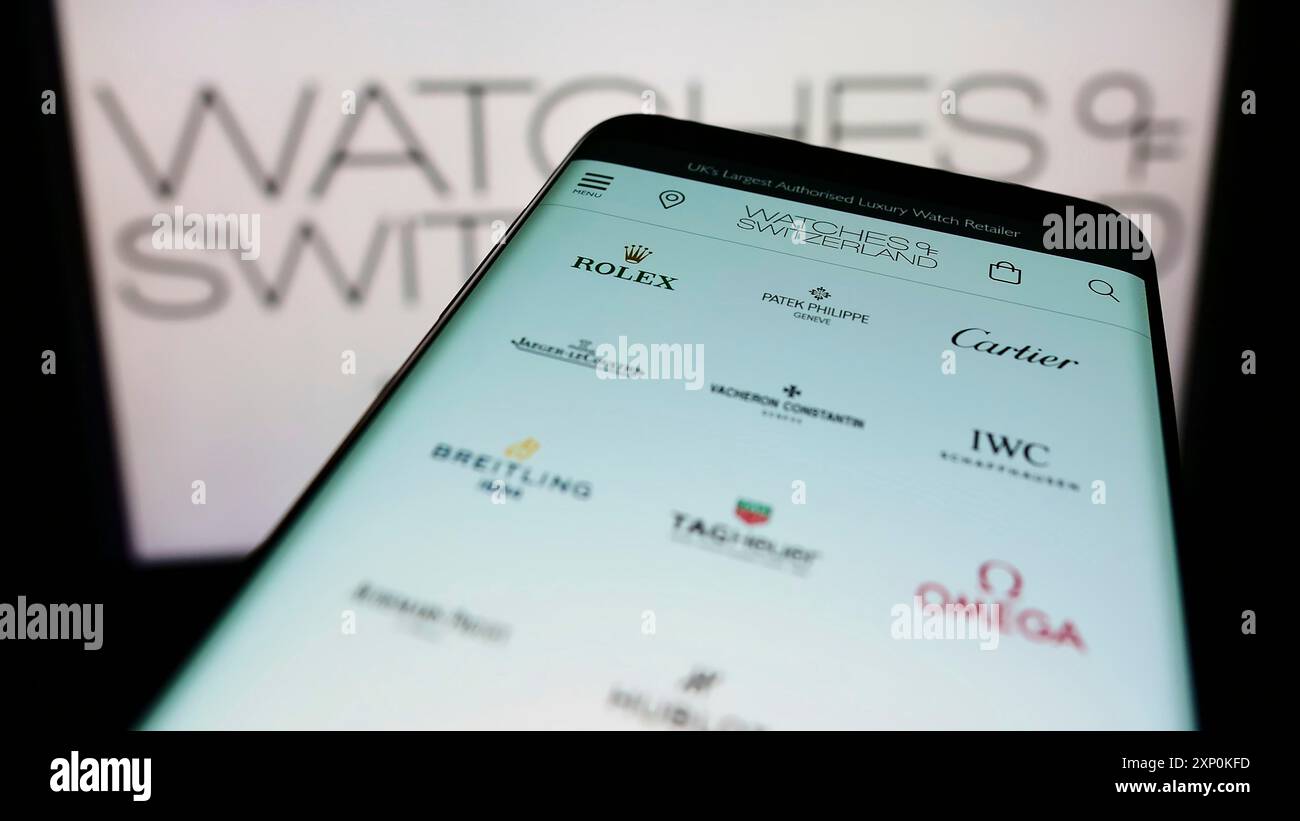 Stuttgart, Germany, 01-16-2022: Mobile phone with webpage of British retailer Watches of Switzerland Group PLC on screen in front of logo. Focus on Stock Photo