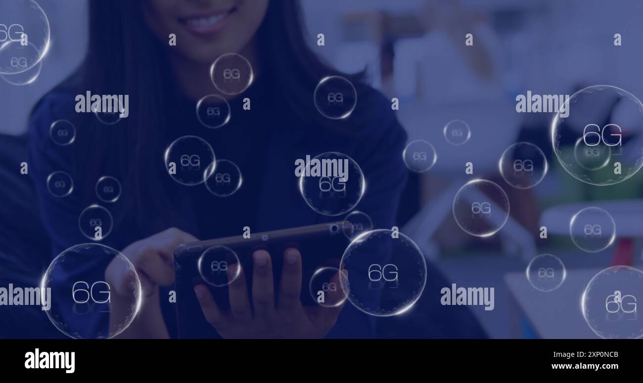 Image of 6g icons over smiling asian woman using tablet Stock Photo - Alamy