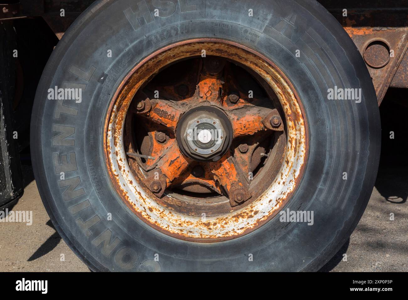 Close-up of Continental HSL tire with rusted metal rim on ...