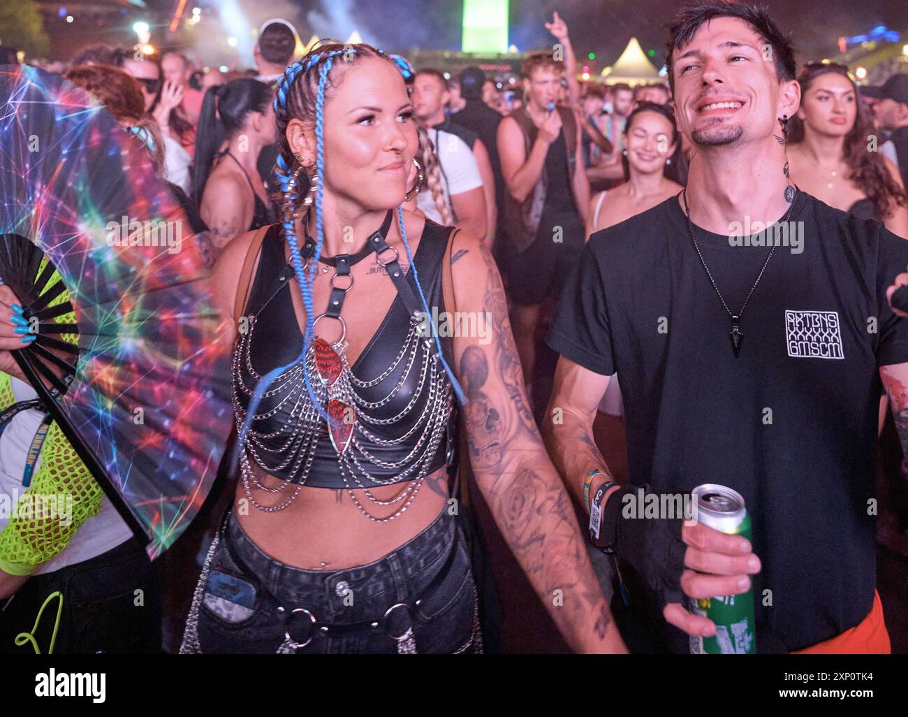 Kastellaun, Germany. 02nd Aug, 2024. The front row of thousands of ravers dances in front of the open-air stage at the Nature One techno festival on the former US missile base in Pydna. For the 28th time, electronic music is booming in the Hunsrück, this year until August 4. (Repetition with a different image section) Credit: Thomas Frey/dpa/Alamy Live News Stock Photo