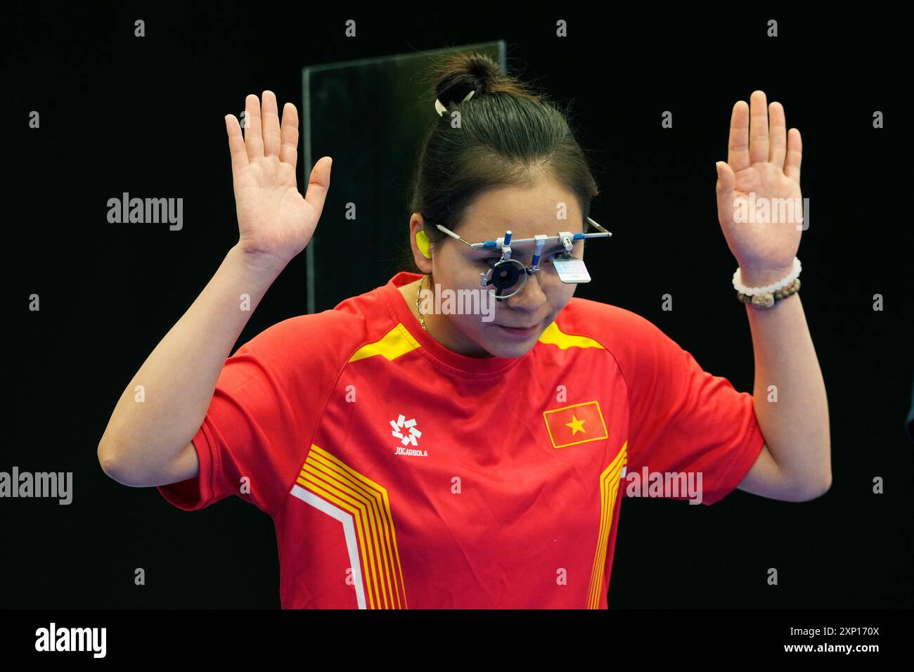 China's Zhao Nan gestures as she is introduced before the 25m pistol ...