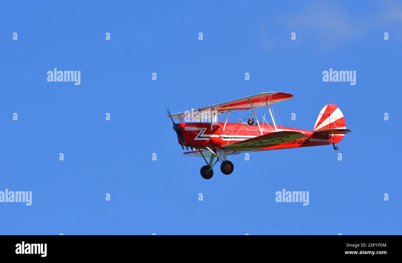 Vintage Red 1949 Stampe Vertongen Biplane in flight Stock Photo - Alamy
