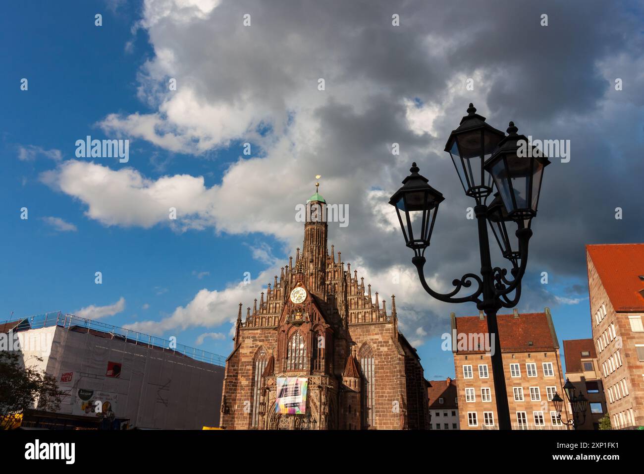 NUREMBERG, GERMANY - MAY 19, 2024: Street lights against the backdrop of Frauenkirche in Nuremberg on a sunny May day Stock Photo