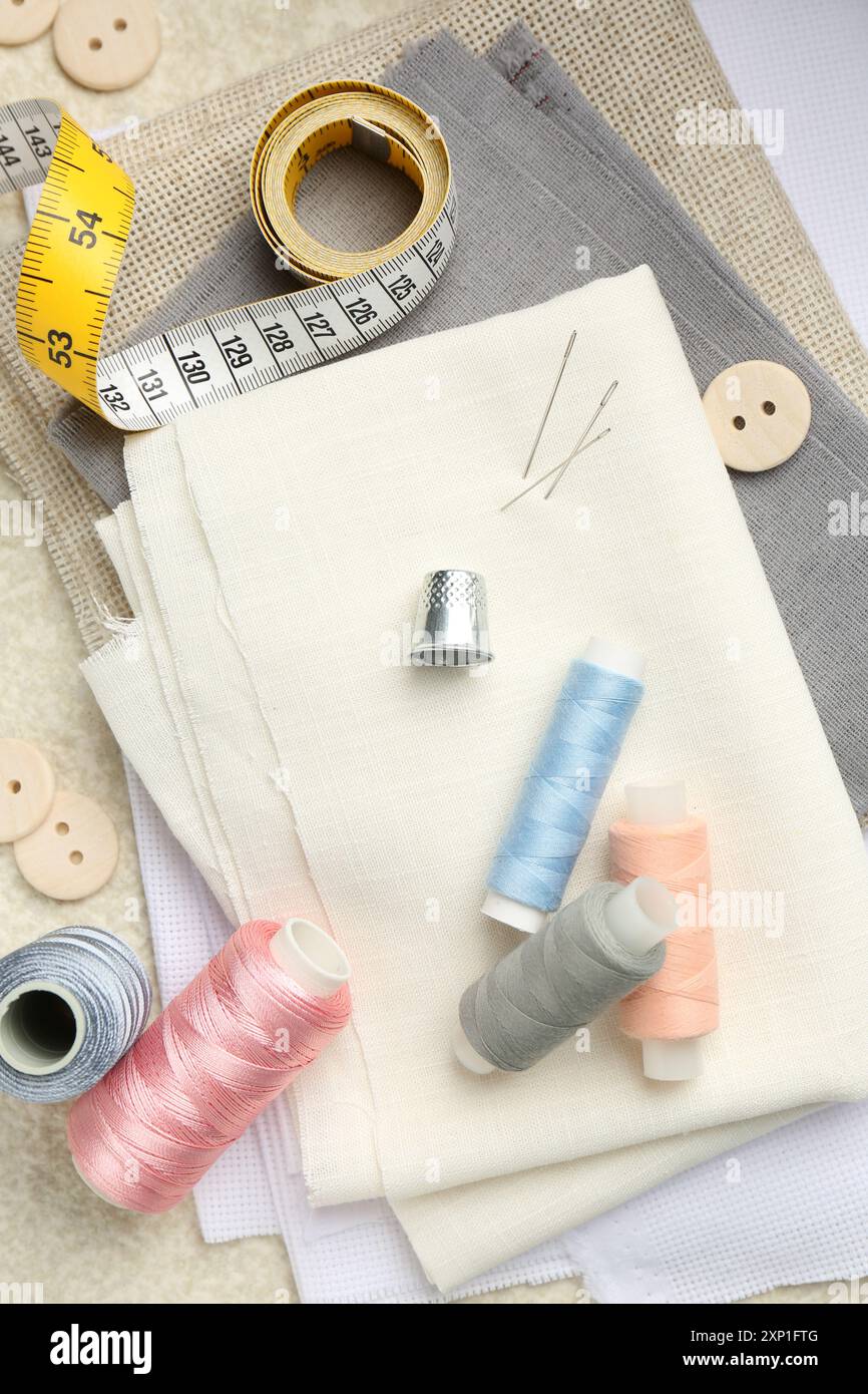Flat lay composition with different sewing supplies on table Stock Photo