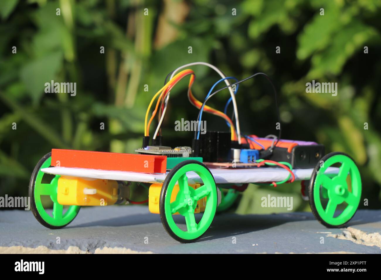Iot powered car made with 3d printed parts and programmable micro controller isolated on a natural background Stock Photo