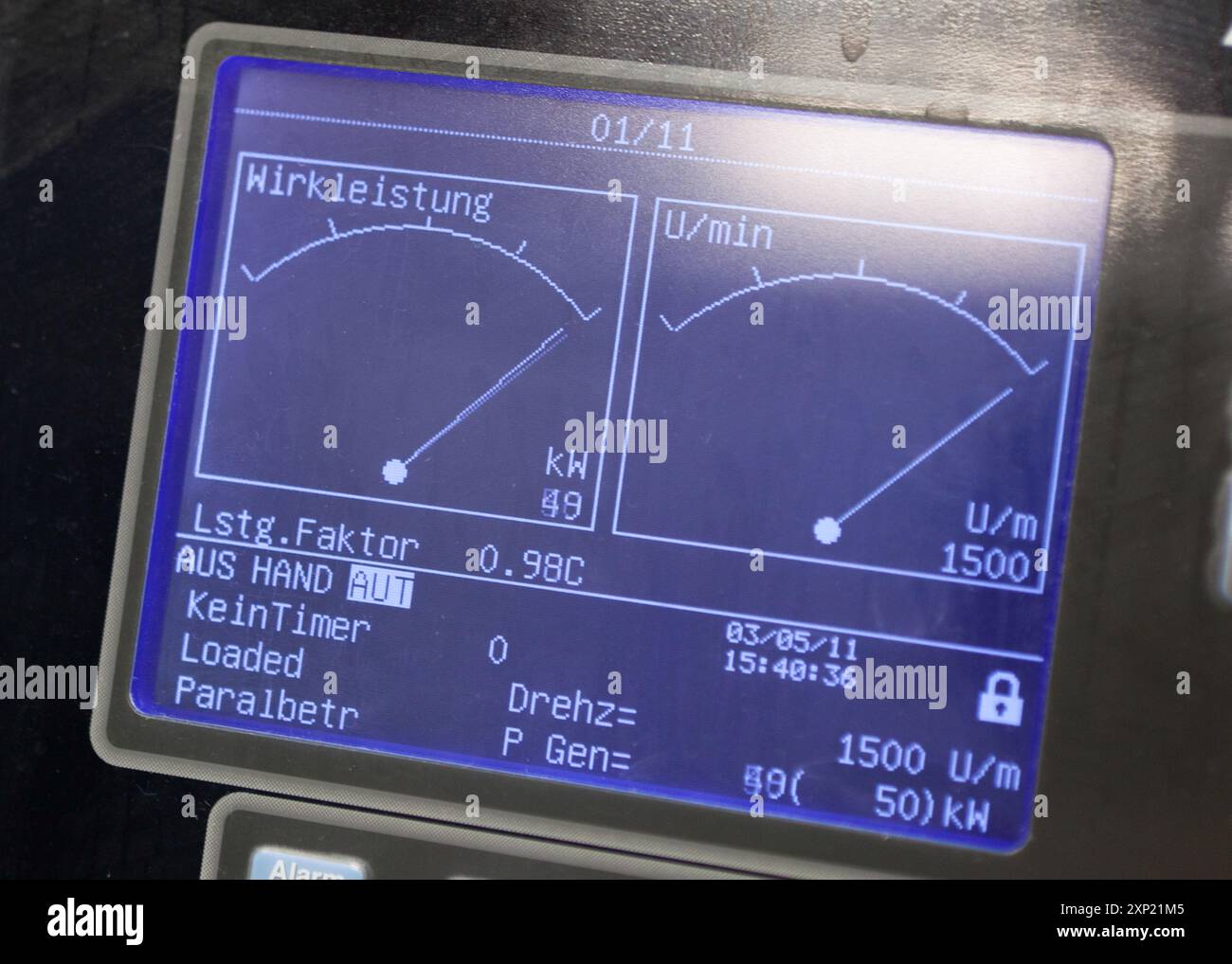 Close-up view of a control panel displaying real-time energy output metrics for a combined heat and power (CHP) plant. Highlighting performance and efficiency data. Stock Photo