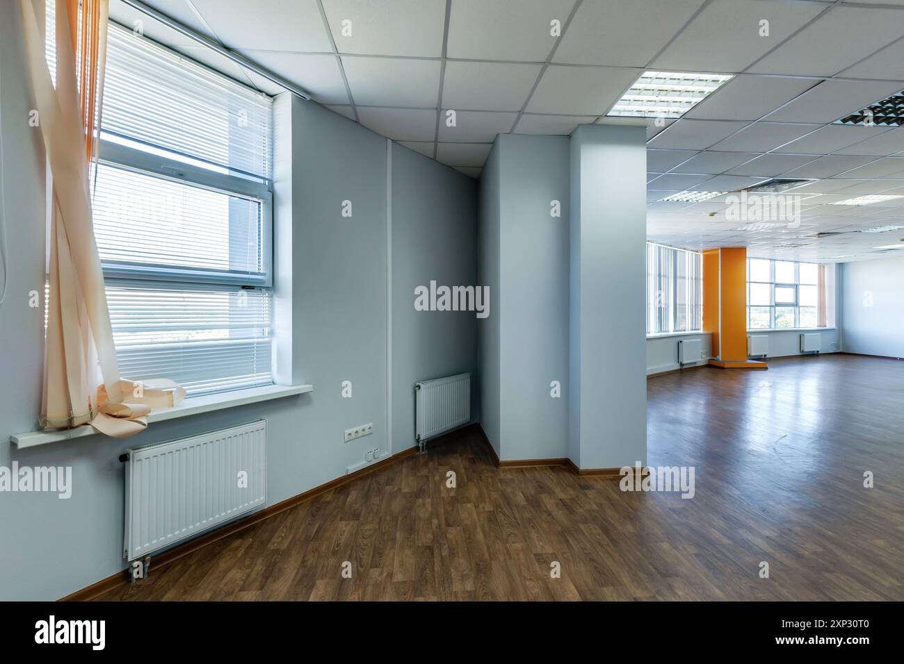 panorama view in empty modern office hall with sunlight in windows. Stock Photo