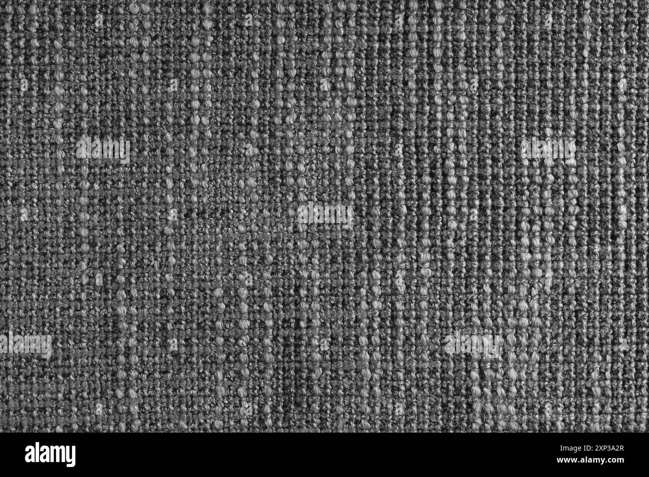 Jacquard woven coarse weave texture upholstery black fabric. Textile background, furniture textile material, wallpaper, backdrop. Cloth structure clos Stock Photo