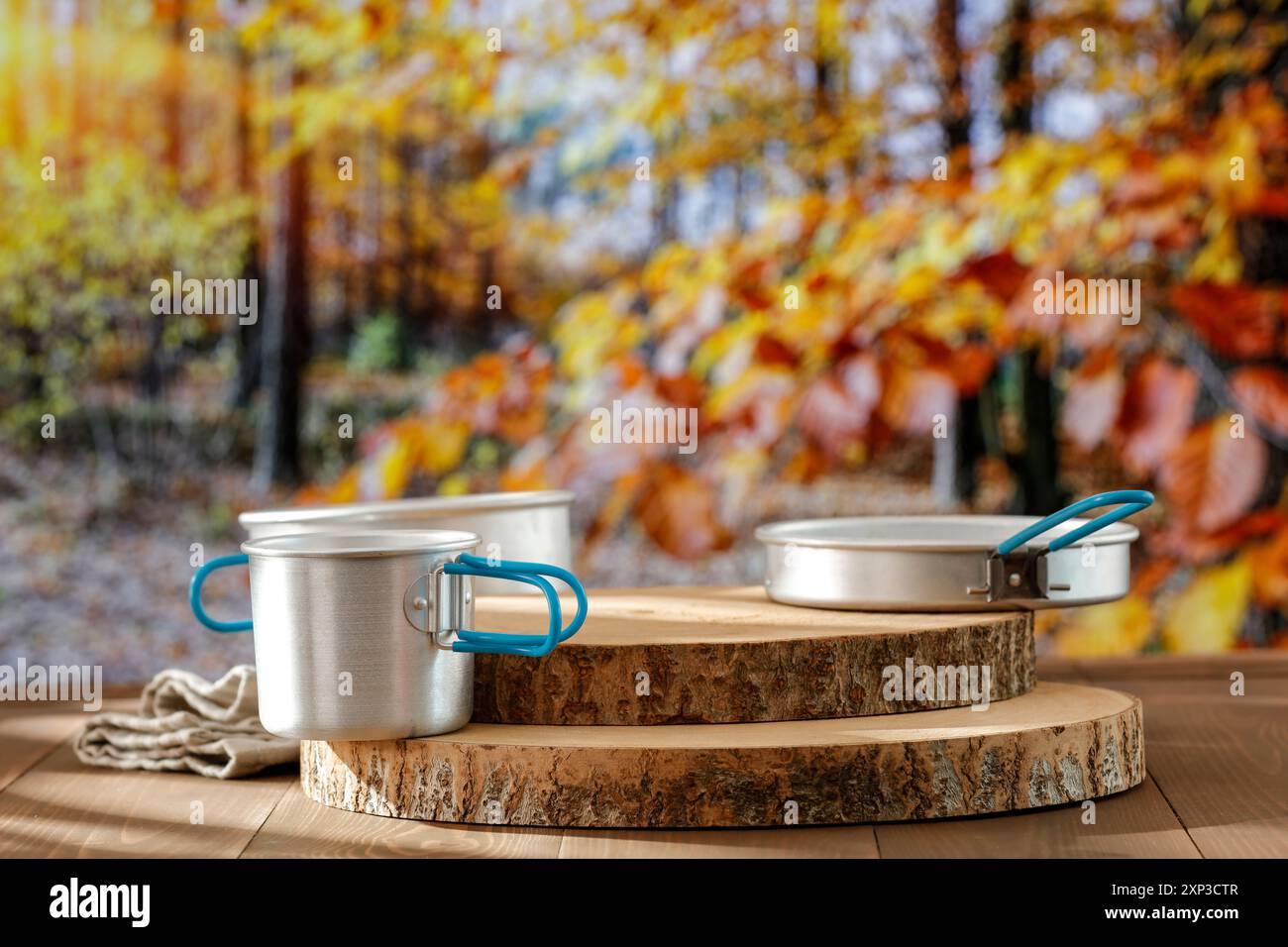 Forest Mess Table Aluminium dishes and mess tin on wooden autumn table and autumn trees ...