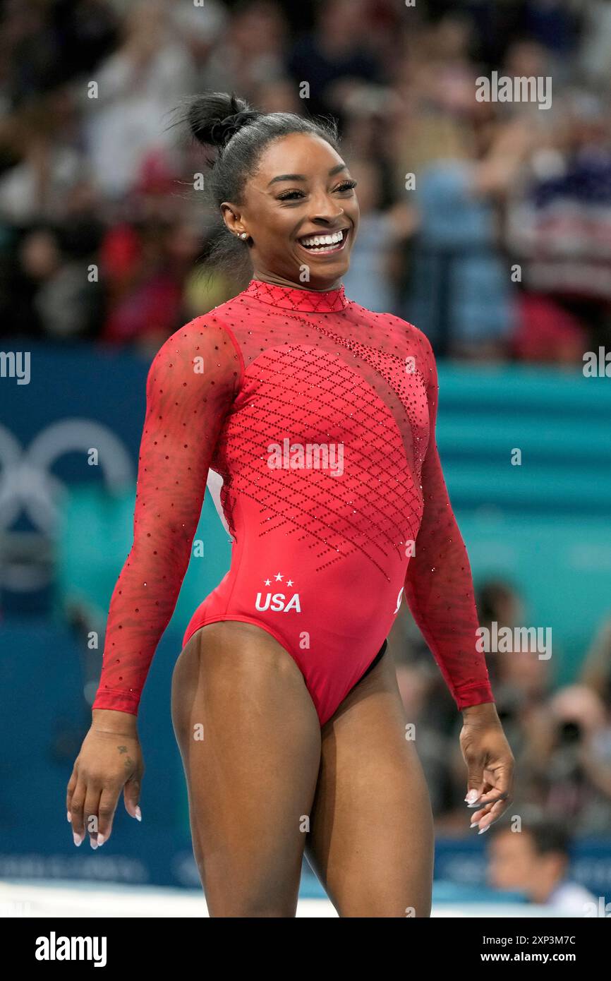 Simone Biles, of the United States, smiles after competing during the ...