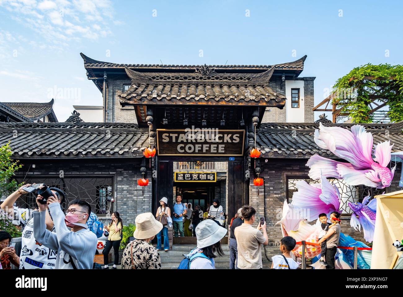 A Starbucks Coffee shop at the historical street crowded with tourists. Chengdu, Sichuan, China. Stock Photo