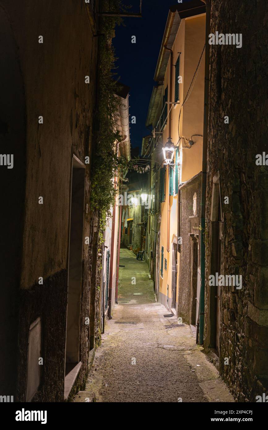 Night time image of a narrow alley in the small medieval town of Fosdinovo in northern Tuscany, Italy. Stock Photo