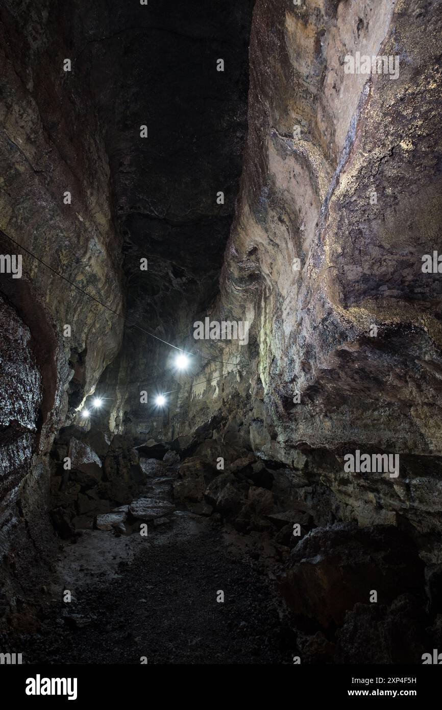 Dimly lit rocky cave passage with uneven rough walls and scattered ...