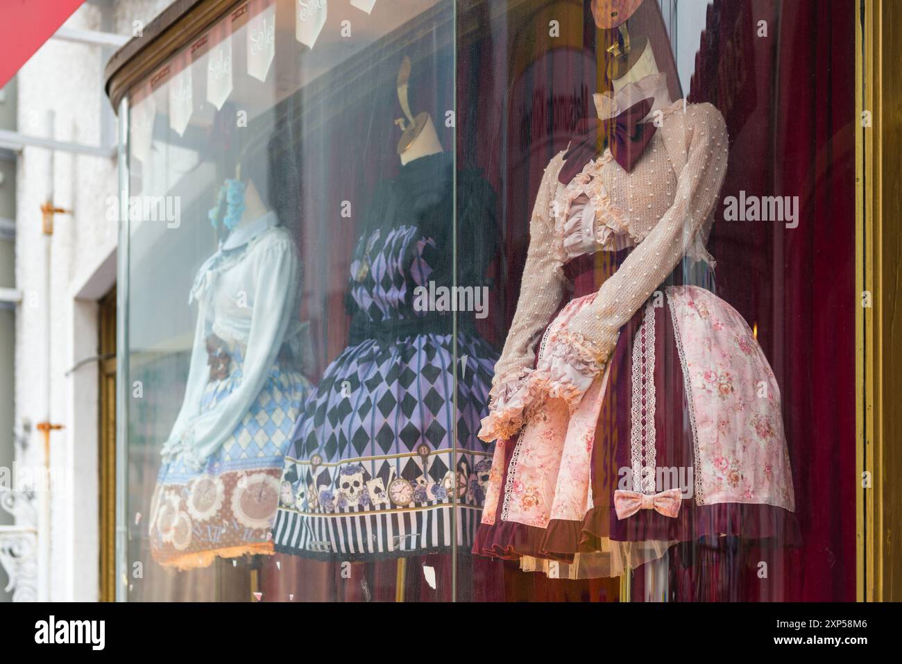 Mannequins in shop window with vintage-style dresses and intricate designs Stock Photo