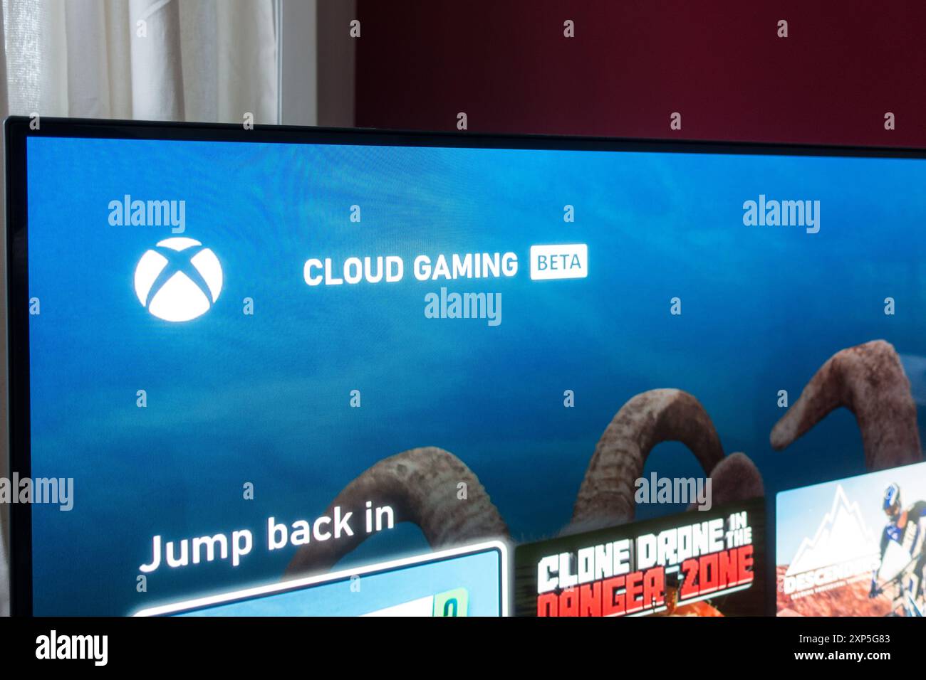 XBOX cloud gaming home screen on TV Stock Photo