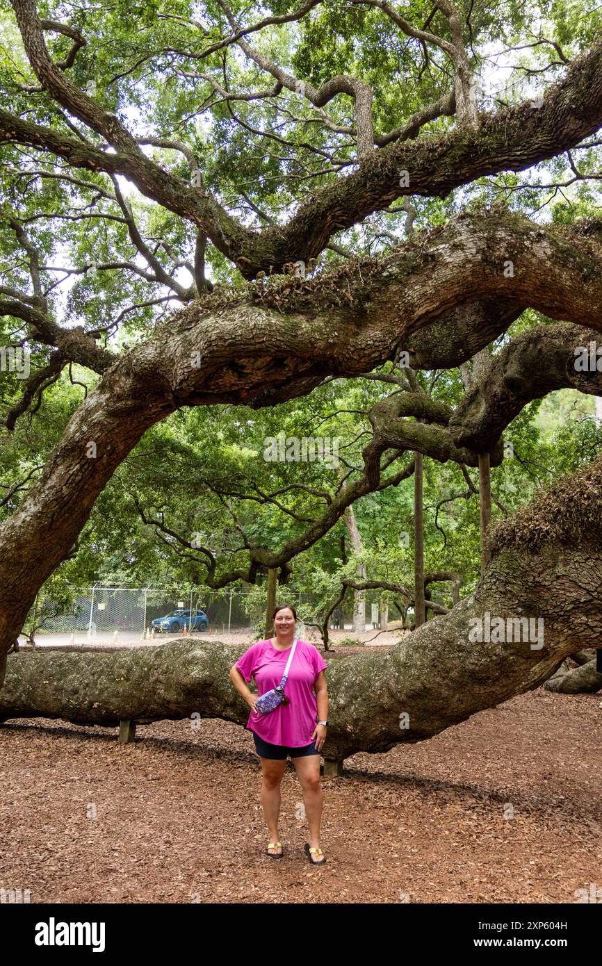 Young woman posing in front of Angel Oak Tree, largest live oak east of ...