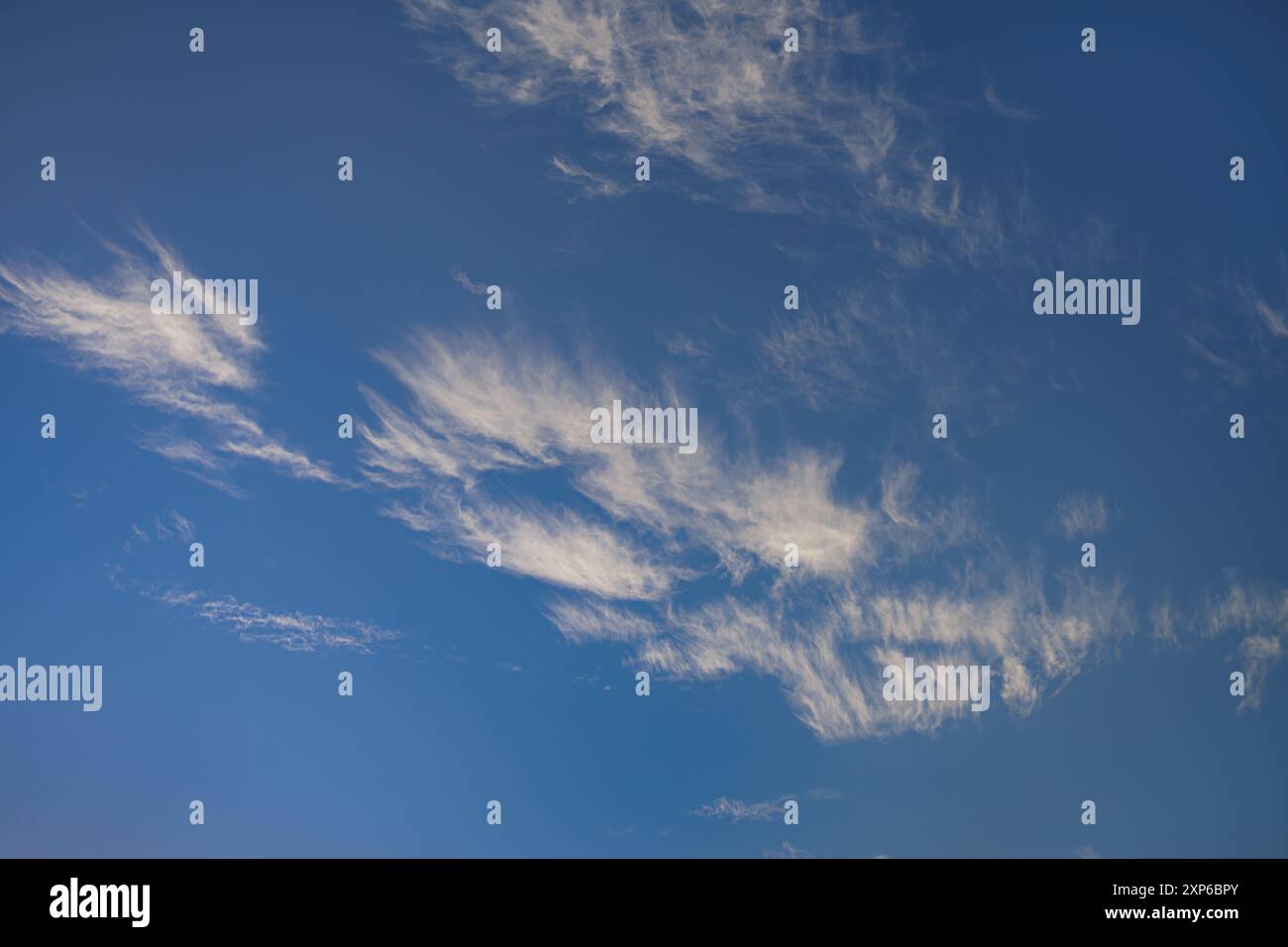 Wispy White Clouds on a Clear Blue Sky Stock Photo